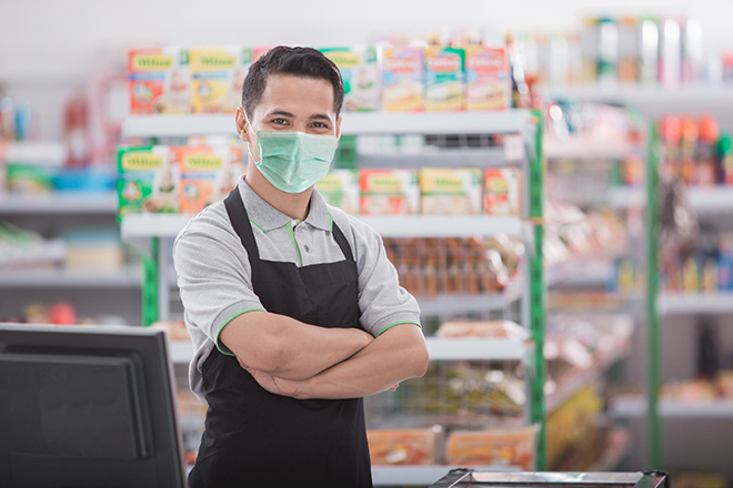 Propietario de comercio local al pie de su negocio