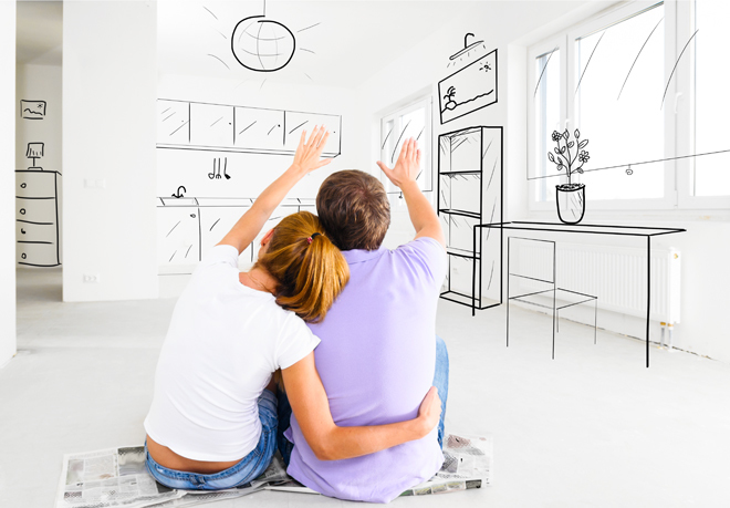 Dos jóvenes sentados de espaldas contemplan el diseño de su nuevo piso